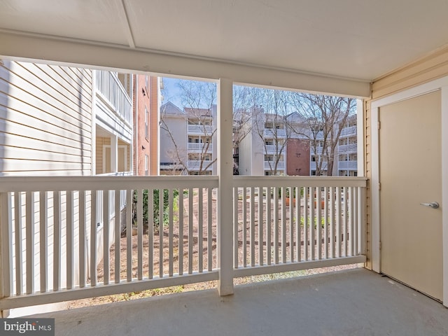 unfurnished sunroom with a residential view and plenty of natural light