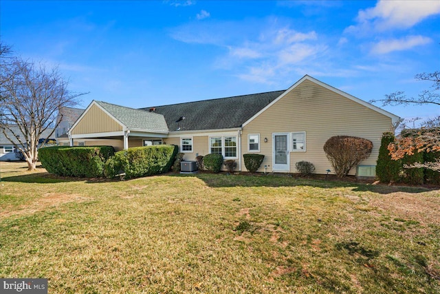 view of front of home featuring cooling unit and a front lawn