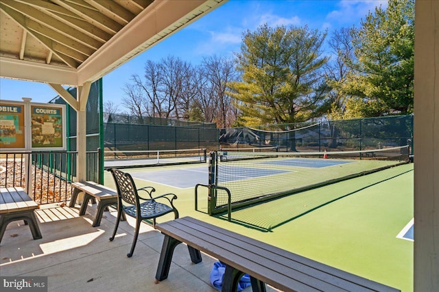 view of tennis court featuring fence