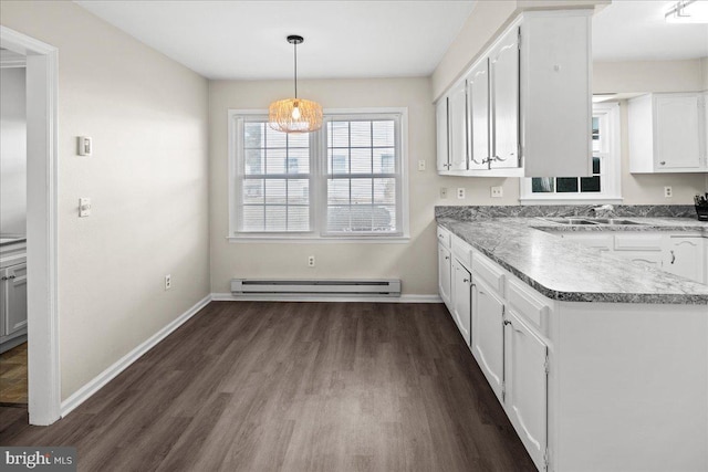 kitchen with a baseboard heating unit, white cabinets, dark wood finished floors, and baseboards