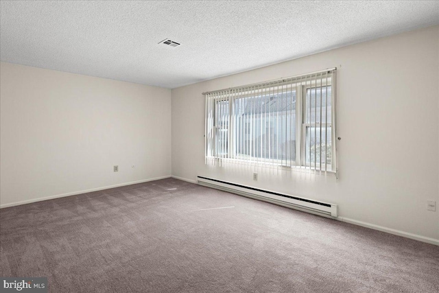 carpeted empty room with visible vents, baseboards, baseboard heating, and a textured ceiling