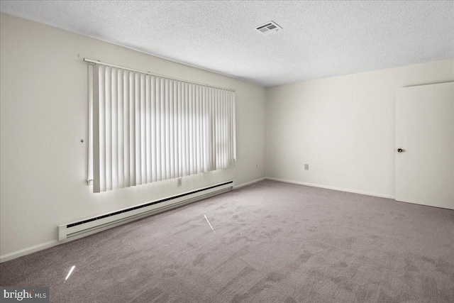 carpeted empty room featuring baseboards, visible vents, baseboard heating, and a textured ceiling