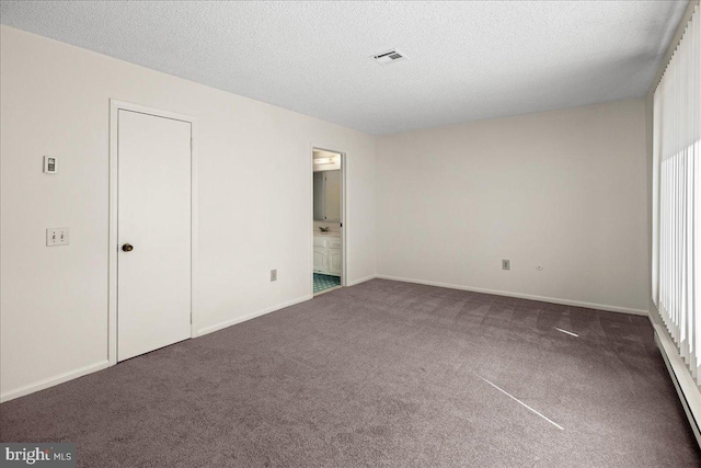 unfurnished bedroom with visible vents, baseboards, a textured ceiling, and carpet flooring