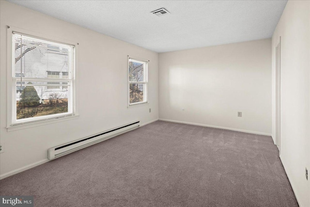 carpeted empty room with a textured ceiling, baseboards, visible vents, and a baseboard radiator