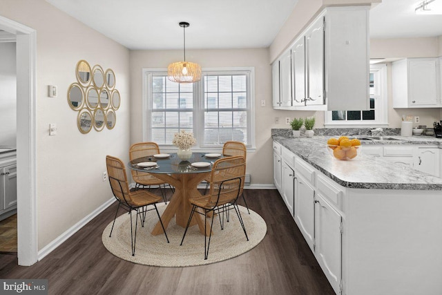 dining area featuring dark wood-style floors and baseboards