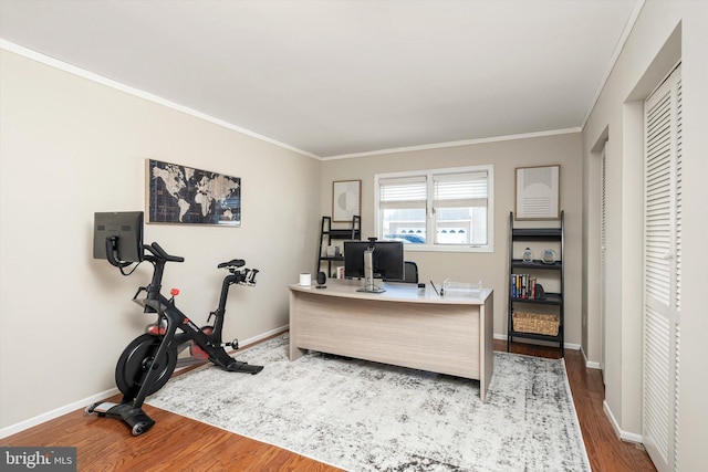 office area featuring baseboards, wood finished floors, and ornamental molding