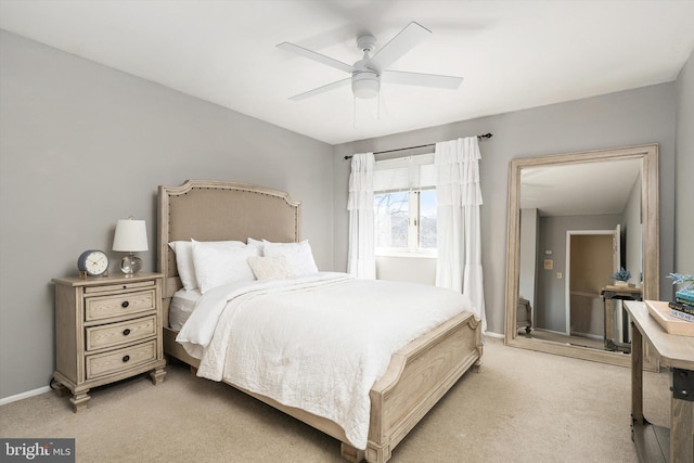 bedroom featuring baseboards, light carpet, and ceiling fan