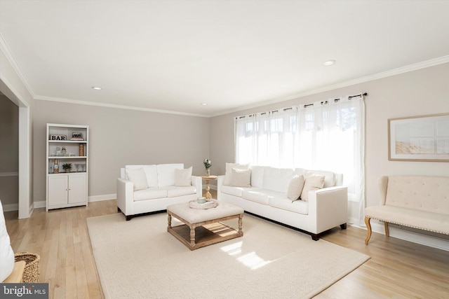 living area with recessed lighting, light wood-style floors, baseboards, and ornamental molding