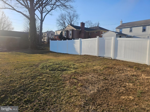 view of yard with a residential view and fence