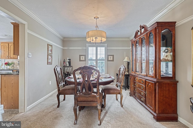 dining area with ornamental molding, light colored carpet, baseboards, and a chandelier