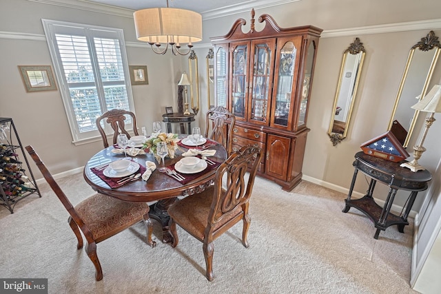 dining space with light carpet, an inviting chandelier, crown molding, and baseboards