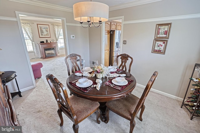 dining space with light carpet, baseboards, and ornamental molding