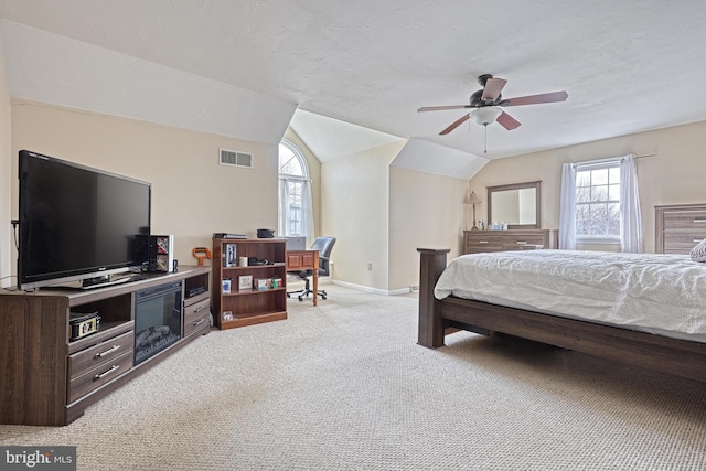 bedroom featuring baseboards, visible vents, vaulted ceiling, a textured ceiling, and light carpet