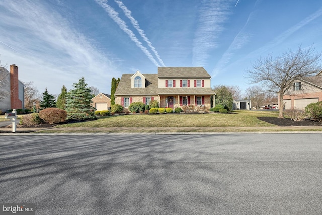 view of front of house with a garage, brick siding, and a front lawn