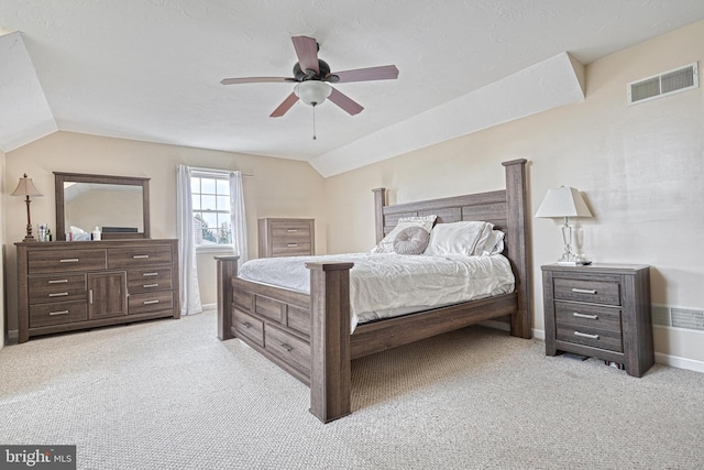 bedroom with visible vents, light carpet, lofted ceiling, baseboards, and ceiling fan