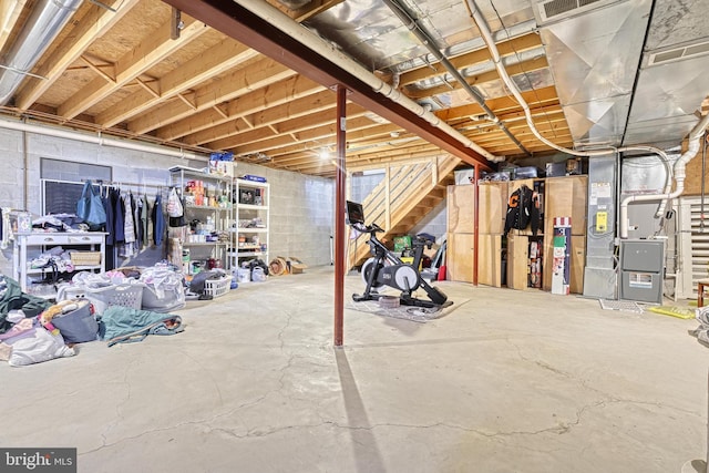 unfinished below grade area with visible vents and concrete block wall