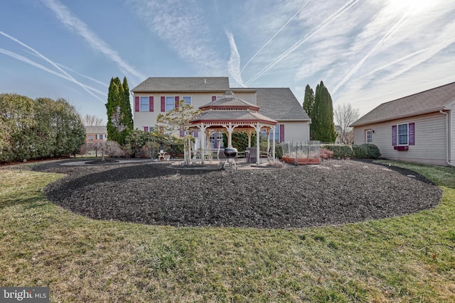 back of property with a gazebo and a lawn