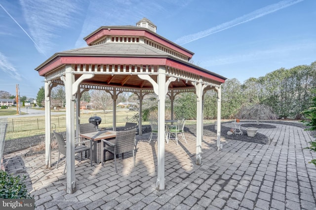 view of patio / terrace with a gazebo, outdoor dining area, and fence