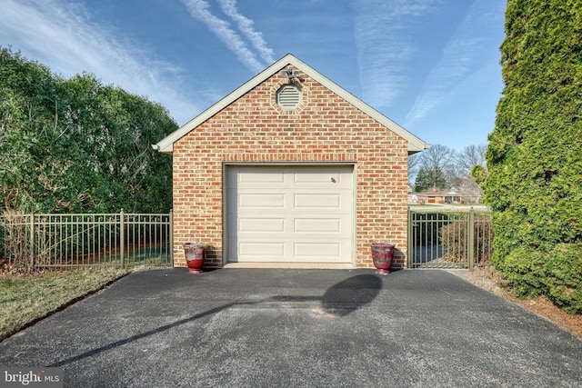 garage with fence and driveway