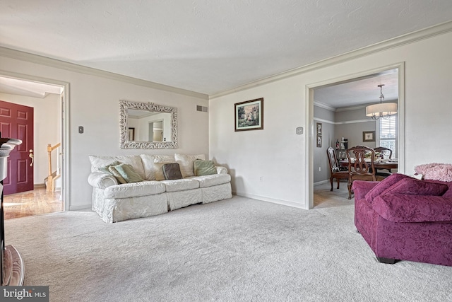 living room featuring baseboards, a notable chandelier, carpet flooring, and crown molding