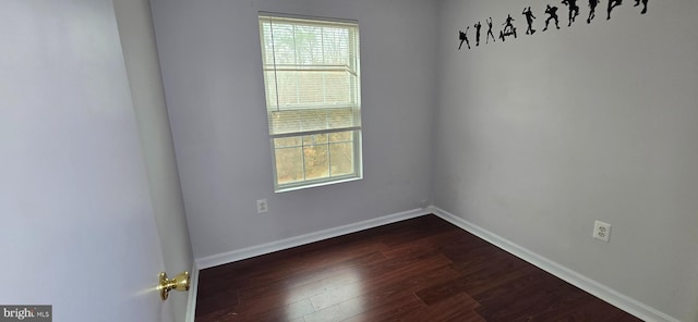 unfurnished room featuring dark wood-type flooring, a healthy amount of sunlight, and baseboards