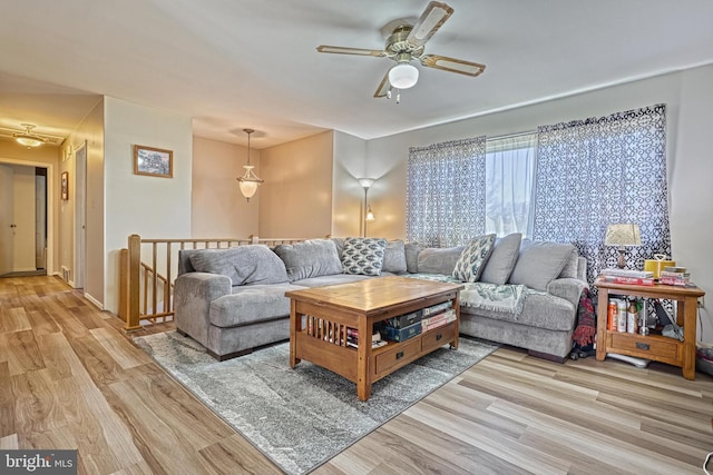 living area featuring a ceiling fan and wood finished floors