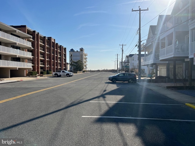 view of street featuring curbs, street lighting, and sidewalks