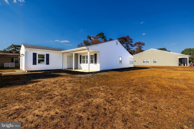 view of front of house with a front lawn and a patio