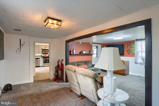 living area with carpet and visible vents