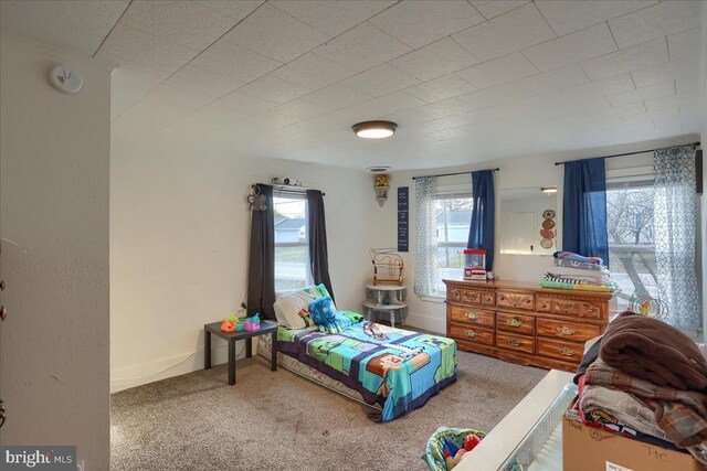 carpeted bedroom featuring baseboards