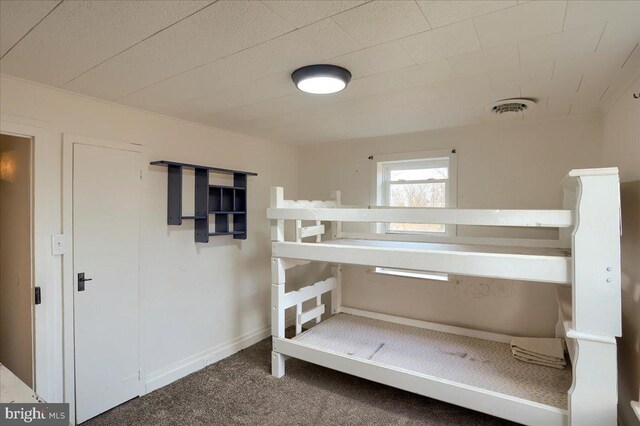 bedroom featuring visible vents, carpet floors, and baseboards