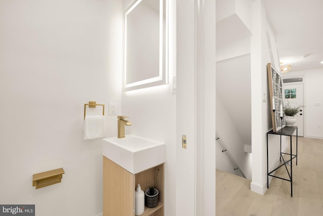 bathroom with wood finished floors and vanity