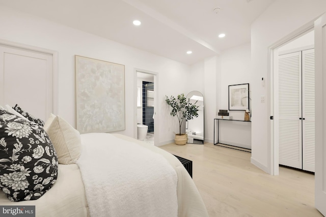 bedroom with recessed lighting, ensuite bath, baseboards, and wood finished floors