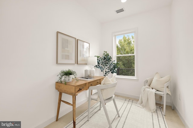 office space with baseboards and visible vents