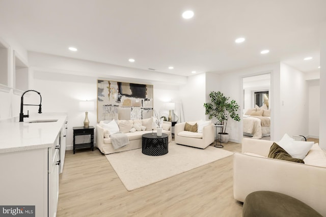 living area featuring recessed lighting and light wood finished floors