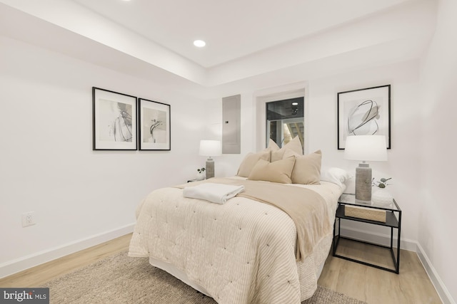 bedroom with recessed lighting, baseboards, and light wood finished floors