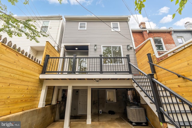 back of house with stairway, central air condition unit, and a patio area