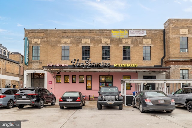 view of building exterior featuring uncovered parking