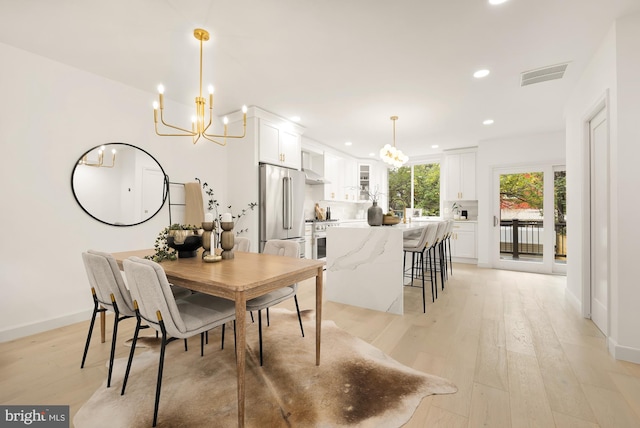 dining room with light wood-type flooring, visible vents, an inviting chandelier, and recessed lighting