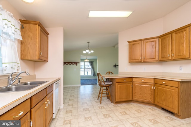 kitchen featuring a sink, dishwasher, brown cabinetry, and light countertops