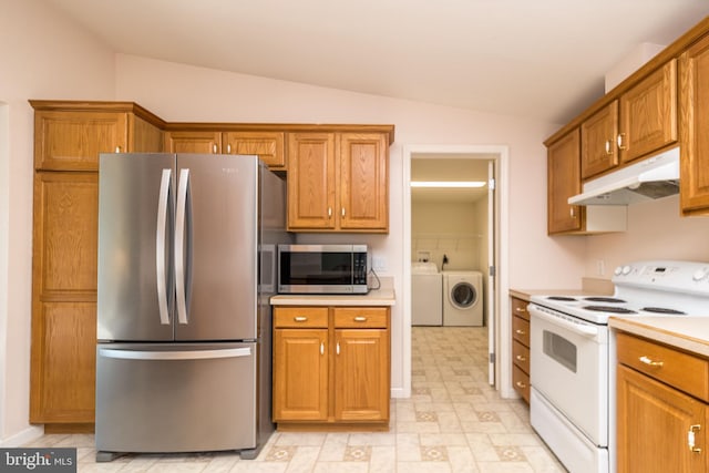 kitchen with washing machine and clothes dryer, lofted ceiling, light countertops, under cabinet range hood, and appliances with stainless steel finishes