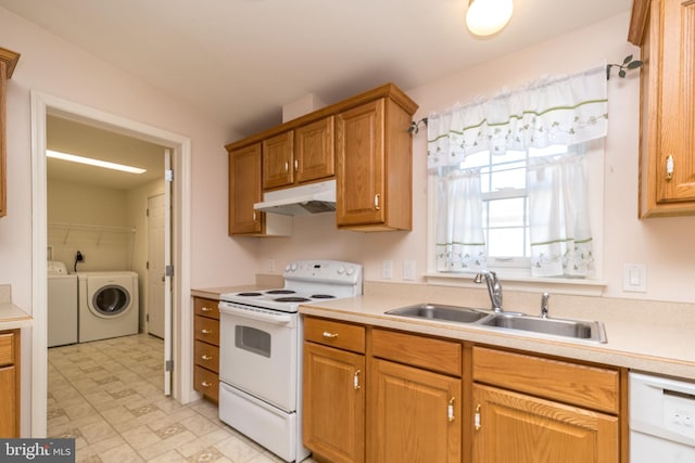 kitchen featuring a sink, under cabinet range hood, washer and dryer, white appliances, and light countertops