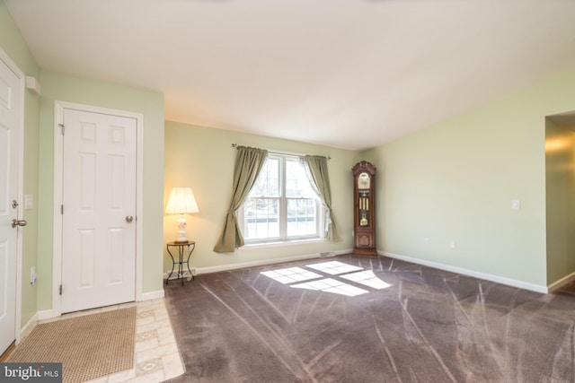 interior space with baseboards and carpet flooring