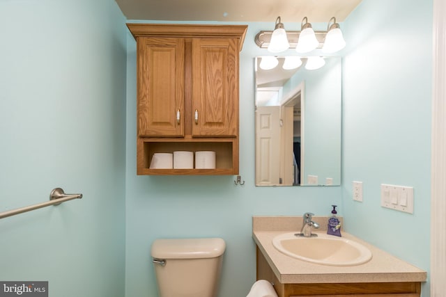 bathroom featuring toilet and vanity