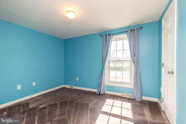 unfurnished room with carpet flooring and baseboards