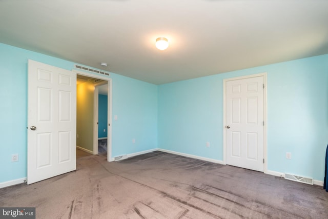 unfurnished bedroom featuring visible vents, baseboards, and carpet flooring