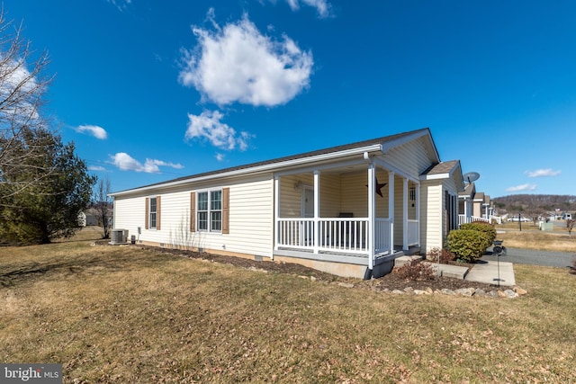 exterior space featuring crawl space, central AC unit, a porch, and a front lawn