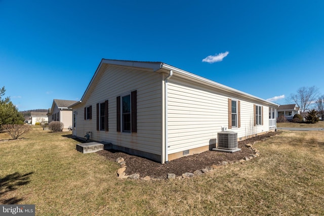 view of property exterior with crawl space, central AC unit, and a lawn