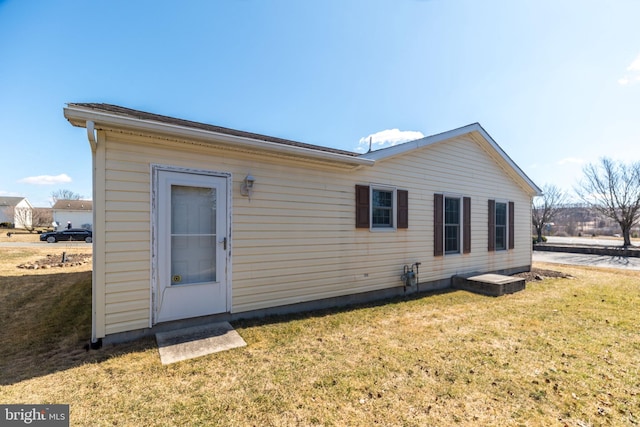 rear view of house with a lawn