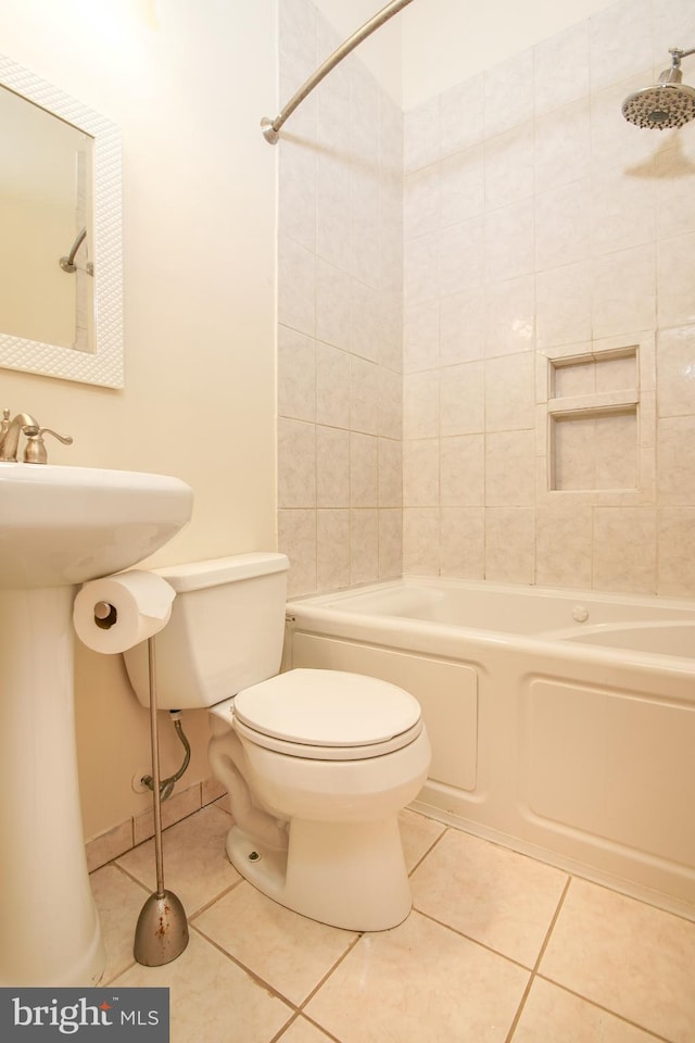 bathroom featuring tile patterned flooring, toilet, and shower / bathtub combination